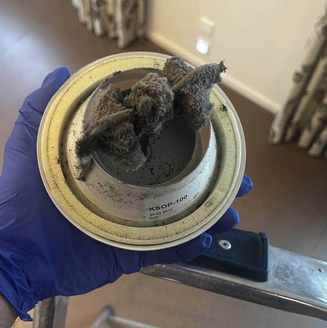 Contaminated air component with visible dust before cleaning.